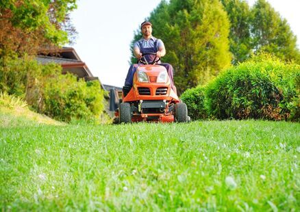 A Landscape Expert Driving Lawn Mower In Atlanta A Landscape Expert Driving Lawnmower In Atlanta